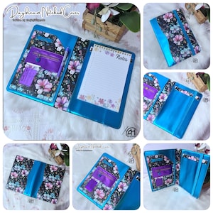 May include: A turquoise Daydream Notebook Cover with floral print accents. The cover features a purple zippered pocket, a pen holder, and a notepad with floral border. The notebook cover is open, revealing the interior design and notepad.