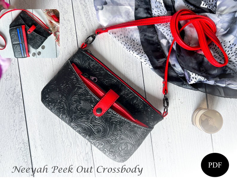 May include: Black crossbody purse with red accents and a floral embossed design. The purse has a zippered pocket and a flap closure with a snap button. The strap is red and adjustable. The text "Neeyah Peek Out Crossbody" is printed below the purse.