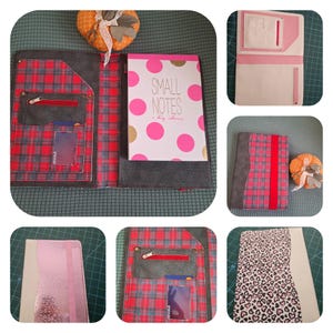 May include: A plaid fabric notebook cover with a red zipper pocket and card slots. A notebook with pink polka dots and the words "SMALL NOTES a big idea" is inside. The cover is open, revealing the interior design.