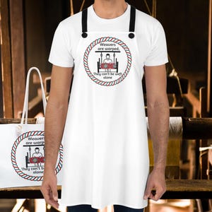 May include: White tote bag and apron with a red, white, and blue circle design. The circle contains a cartoon image of a person weaving on a loom. The text reads "Weavers are warped, They can't be weft alone."