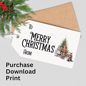 May include: A white Christmas gift tag with the text "Merry Christmas" in black script. The tag features a festive illustration of a Christmas tree, a nutcracker, and other holiday characters. A brown envelope is behind the tag.