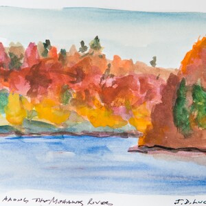 May include: Watercolor painting of a river scene with autumn foliage. The artwork features a blue river, with banks lined by trees in shades of red, orange, yellow, and green. The text "Autumn Along the Mohawk River" is visible.