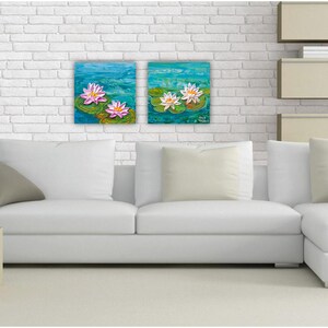 May include: Two framed paintings of water lilies on a white brick wall above a white sectional sofa with gray throw pillows.