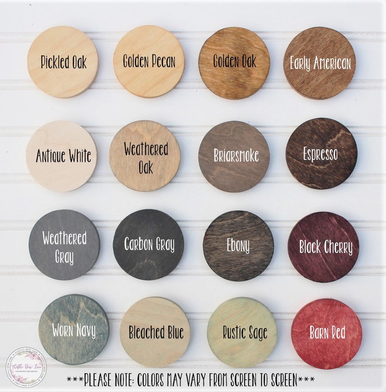 May include: A chart of 16 different wood stain colors, each color is displayed on a round wooden disc. The colors include: Pickled Oak, Golden Pecan, Golden Oak, Early American, Antique White, Weathered Oak, Briarsmoke, Espresso, Weathered Gray, Carbon Gray, Ebony, Black Cherry, Worn Navy, Bleached Blue, Rustic Sage, and Barn Red. The text "***PLEASE NOTE: COLORS MAY VARY FROM SCREEN TO SCREEN***" is at the bottom of the chart.