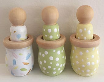 wooden peg dolls in cups