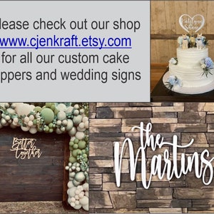 May include: Image features custom cake toppers, wedding signs, and a decorated cake. The cake has a topper with names and figurines. A wooden sign says "Better Together" and another says "The Martins". The text "www.cjenkraft.etsy.com" is also visible.