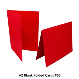 May include: Two red folded blank cards, A2 size. The cards are folded in half and are lying flat on a white background. A2 Blank Folded Cards #65