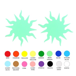 May include: Two light green paper sun shapes with 12 points each. The suns are on a white background. Below the suns are 12 colored circles, each with a label underneath. The colors are red, orange, yellow, light yellow, green, mint green, blue, ocean blue, light blue, natural brown, pink, light pink, purple, black, light gray, and white.