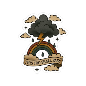 May include: A sticker featuring a traditional tattoo design. It depicts a dark cloud with a lightning bolt, a rainbow, raindrops, and the text "THIS TOO SHALL PASS" on a banner. The design includes stars and tan-colored clouds.