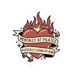 May include: A sticker featuring a red heart with flames, dumbbells, and the text "Mentally at Pilates. Physically losing my mind." The design has a vintage tattoo style with a white background.