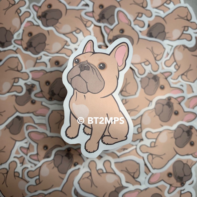 May include: A sticker featuring a cartoon illustration of a fawn-coloured French bulldog with a white heart on its chest. The sticker is surrounded by other stickers of the same dog in various poses.