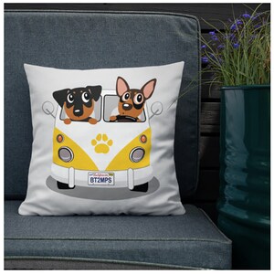 May include: White throw pillow with a cartoon image of two dogs driving a yellow and white vintage van. The van has a paw print on the side and a California license plate that reads "BT2MPS".