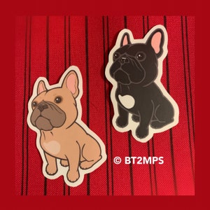May include: Two cartoon French Bulldog stickers, one black and one tan, with white heart markings on their chests. The stickers are on a red and black striped background.