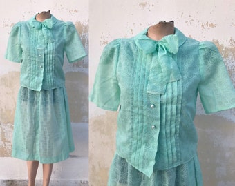 Sea foam green 70s vntg two piece ensemble: lightweight, sheer buttoned bow jacket and same patterned skirt suit feat round floral pattern