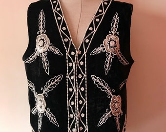 Beaded 80's vintage black velour vest featuring dark colored leaf designs with golden details and gold rounded buttons. Unisex