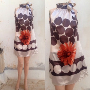 Satiny mini dress 90s does 60s with bow tie neckline and huge polka dot pattern in beige n brown plus one big orange daisy