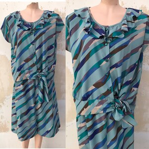 May include: A blue and brown striped dress with a ruffled collar and a tie at the waist.