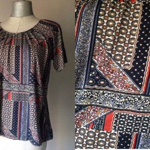 Bohemian loose Carmen style blouse with short sleeves and baroque/abstract mixed patterns in dark colors