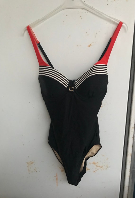 One Piece Black Swimsuit With Striped Detailing on the Bust, Golden Buckle  and Contrasting Orange Straps. Small Size 