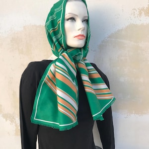 Early 70s long striped scarf in green. Nice color and design, terital scarf with short fringy edges