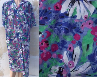 Lushly floral sheer 1980s shirt dress features big white margaritas on blue background with green & some fuchsia