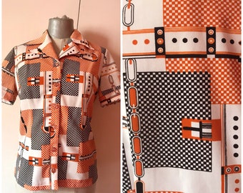 60s -or early 70s- op art buttoned blouse features checkered pattern mixed with belt prints in orange/black and white