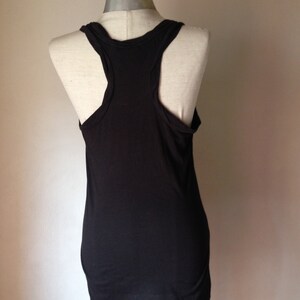 Op de afbeelding: Een zwart tanktop zonder mouwen met een racerback-ontwerp. Het tanktop is gemaakt van een zachte, rekbare stof.