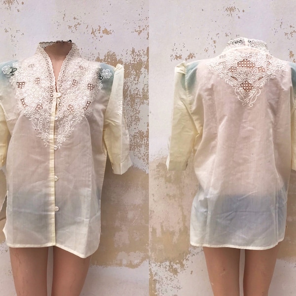 Yellowish/light beige 70s buttoned blouse, feat rich ornate embroidery, cut outs, high neckline and leg o mutton sleeves. Stunning!