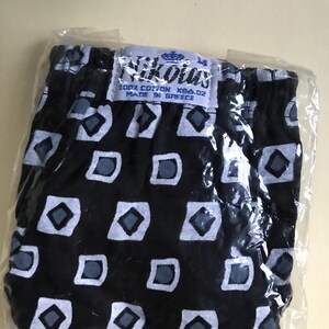 May include: Black and white patterned underwear with a blue label that reads "Nikolas 100% Cotton K94.02 Made in Greece".