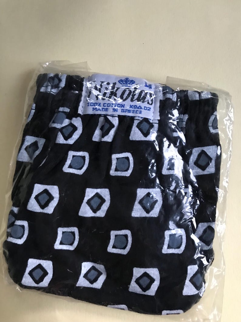 May include: Black and white patterned underwear with a blue label that reads "Nikolas 100% Cotton K94.02 Made in Greece".