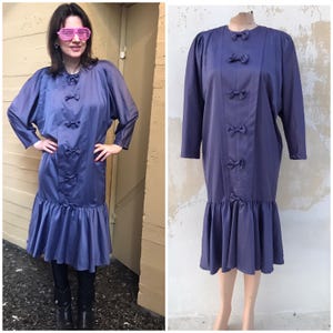 80s vintage satiny purplish long party dress with pleated finishing, puffy, batwing sleeves and bow detailing. So nostalgic & kitschy cute!