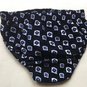 May include: Black underwear with a white geometric pattern.