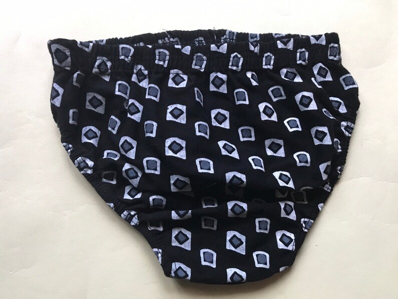 May include: Black underwear with a white geometric pattern.