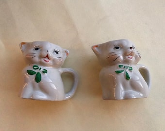 Two cat milk pots or flower pots, 50s/60s vintage. Cute smiling kitties with green bow and tail handles