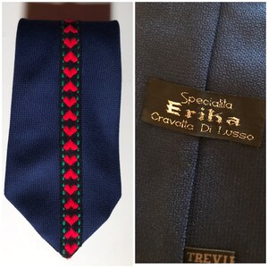 70's vintage chunky knitted dark blue, wide necktie, that features trim with embroidered hearts in the middle, by Erika, Italy