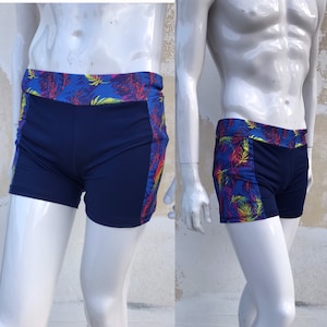 00s does 80s in retro style swimming trunks for men in dark blue with colorful Fluor wide panels on waist and each side