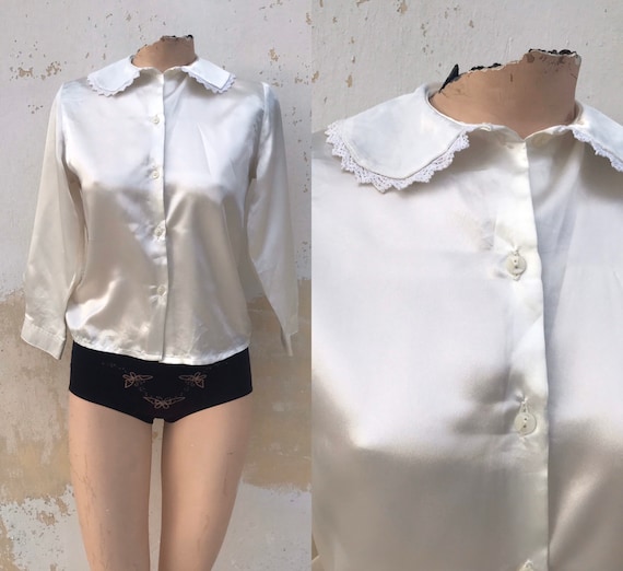 Satiny white 80’s buttoned blouse features laced P