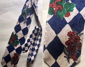 Cosplay, rhombus, satiny 80s vintage clown, kitschy/artistic blue/white necktie features three bouquet of flowers here and there