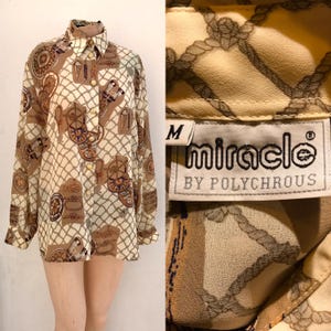 With navy styled prints 80s vintage beige/brown collared buttoned blouse that features ropes, compasses and other relatable designs