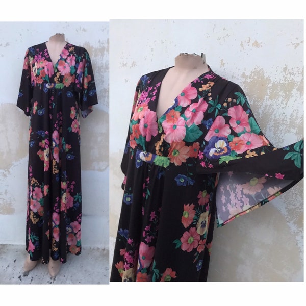 Maxi 70's vintage tunic styled, boho dress in colorful, lush floral pattern that features angel sleeve, flared skirt, empire waistline