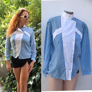 Double breasted 1980 vintage white buttoned blouse features sheer lightweight fabric and ruched shoulders Unworn with its labels on