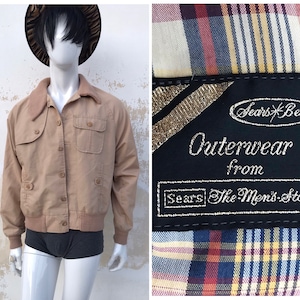 May include: A tan jacket with a corduroy collar and two flap pockets. The jacket has a label that reads "Sears Best Outerwear from Sears The Men's Store".