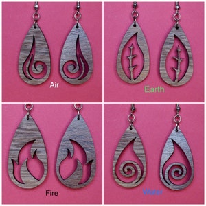 May include: Four pairs of wooden earrings, each pair featuring a different element: air, earth, fire, and water. The earrings are shaped like teardrops and have intricate cutouts representing each element.