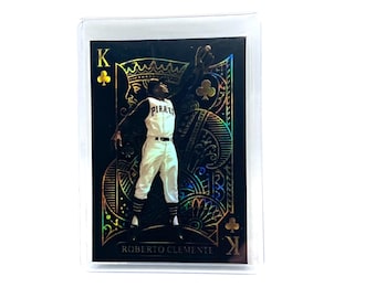 May include: A collectible trading card featuring Roberto Clemente in a white Pirates uniform, depicted as the King of Clubs. The card has a black background with holographic foil accents, ornate patterns, and the text K, Roberto Clemente.