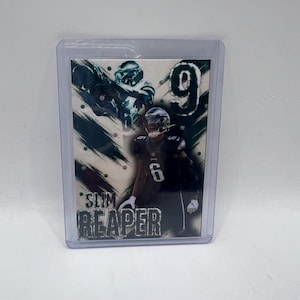 May include: A sports trading card featuring a football player in a dark uniform with the number 6. The card has the words "SLIM REAPER" printed on it. The background has green and white accents.