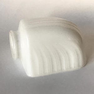 May include: A white milk glass light shade featuring a smooth, rounded rectangular shape with a circular opening on one side. The surface is decorated with subtle, raised vertical ribbed lines that curve along the top and sides of the glass.