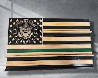 May include: Wooden American flag with the United States Army emblem. The flag features black and natural wood stripes, a green stripe, and a black base. The emblem includes the words "United States Army".