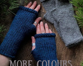 May include: A pair of dark blue fingerless knit gloves with a ribbed texture and rolled edges, accompanied by a separate pair of grey fingerless knit gloves with a similar ribbed design and rolled edges, featuring the text MORE COLOURS.