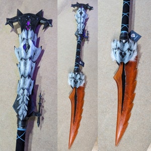 May include: A fantasy weapon with a black and white handle, a blade with orange and black accents, and a decorative top. The weapon has a detailed design with a combination of sharp and curved elements. The overall aesthetic is reminiscent of a fantasy game or movie prop.