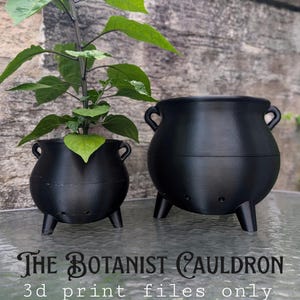 May include: Two black, three-legged cauldron-shaped planters with side handles. One contains a green leafy plant. Text reads: THE BOTANIST CAULDRON 3d print files only. The planters feature small drainage holes near the base and a smooth finish.